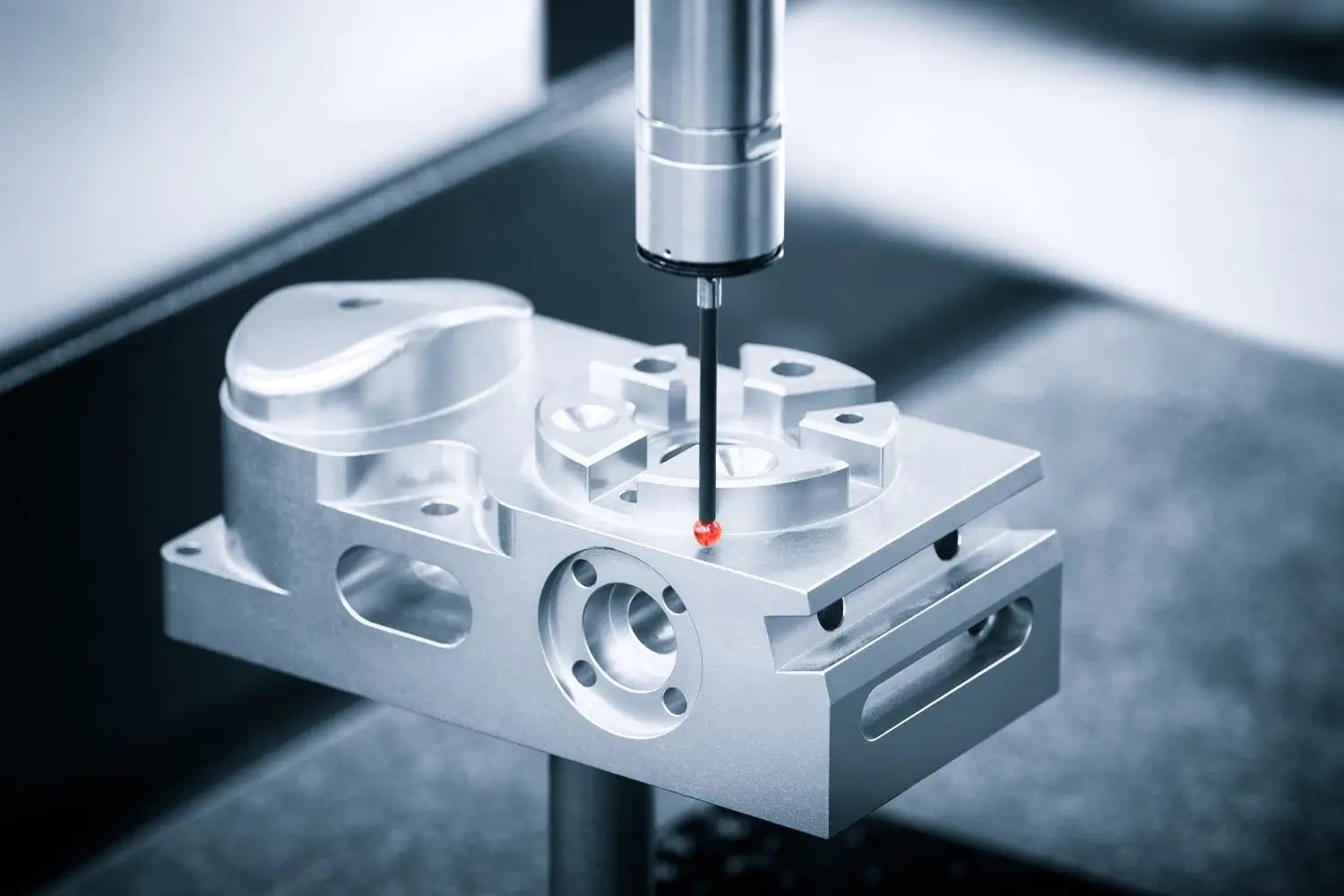 A precision measurement probe inspecting a machined metal component, representing advanced manufacturing processes and quality control in machining.