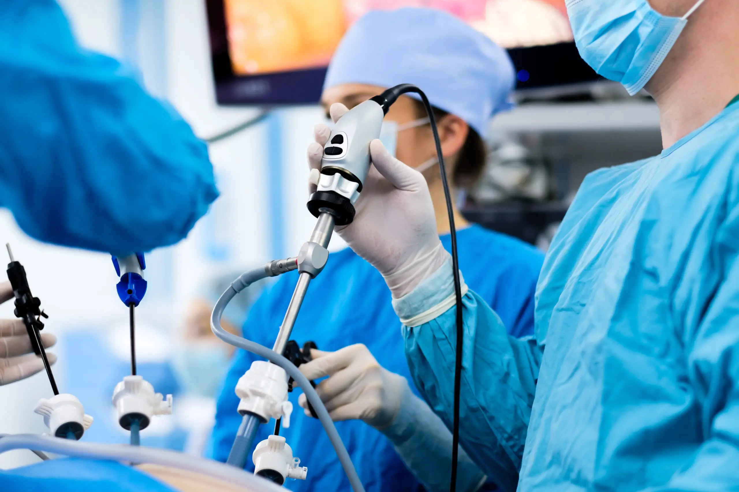 Surgeons performing a minimally invasive procedure using endoscopic tools, representing advanced medical technology and precision in surgical operations.