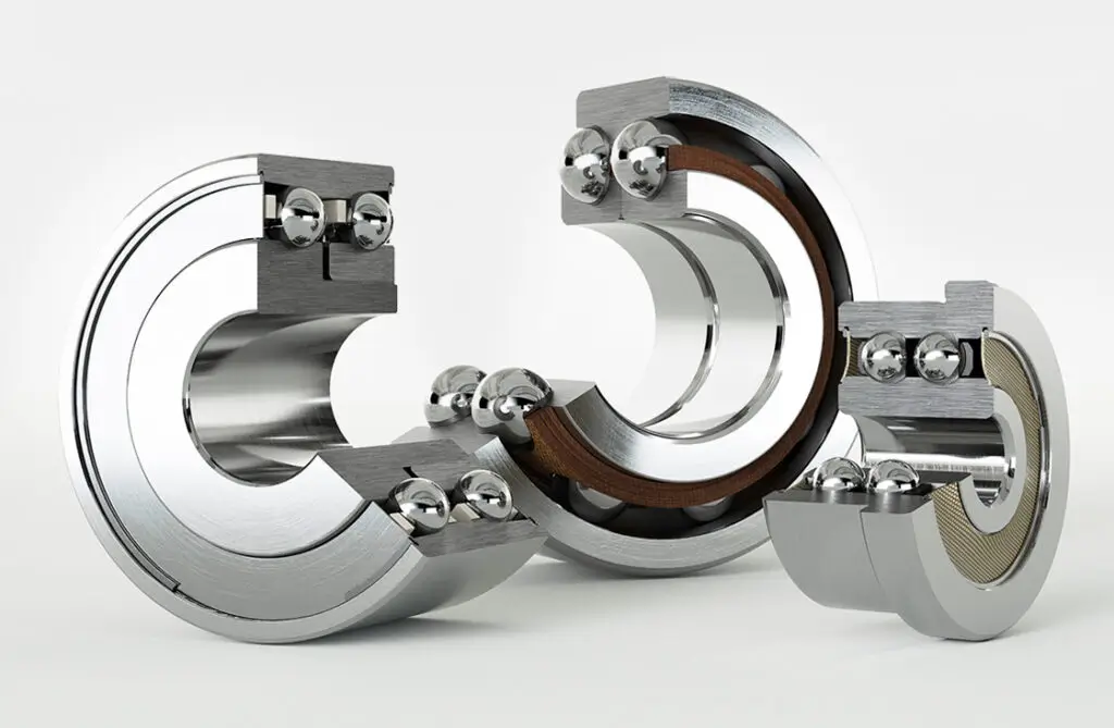 Close-up of duplex ball bearings supplied and distributed by IEC Ltd, shown on a metallic surface.