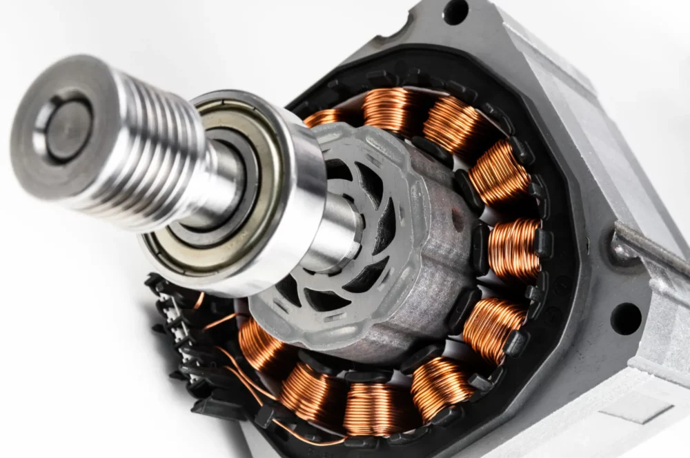 Close-up view of an electric motor rotor with visible copper windings and precision-engineered components.